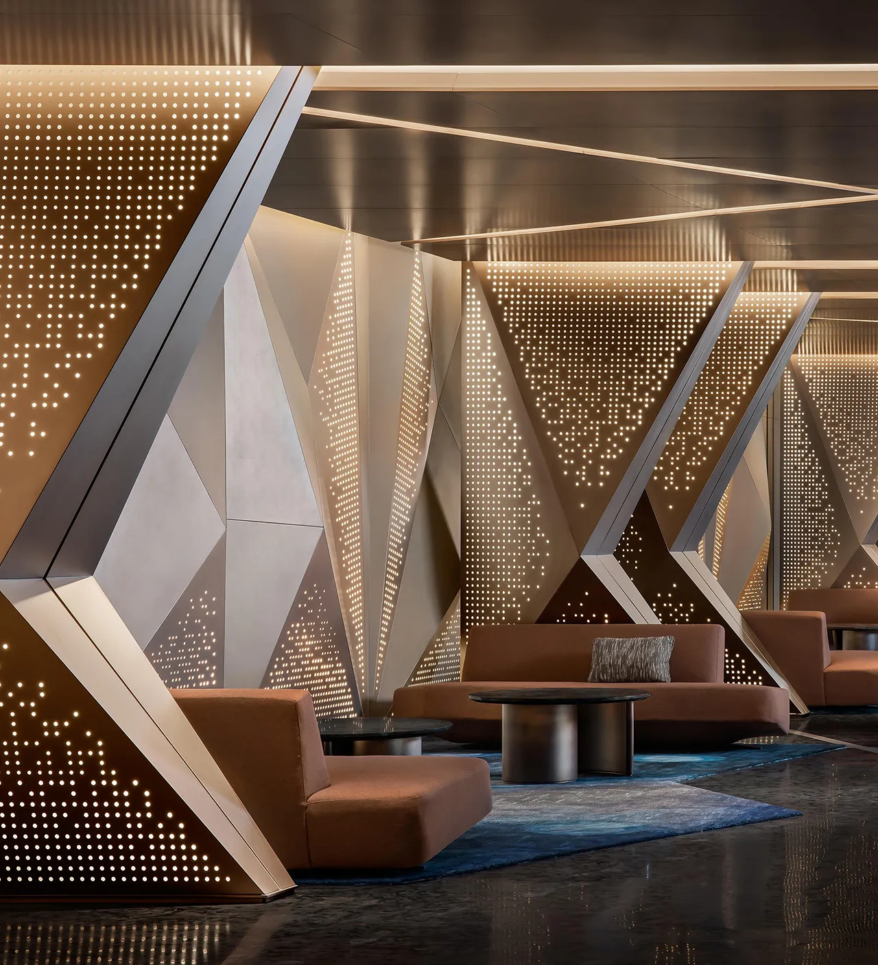 Aluminium perforated panel with golded finish used as indoor cladding at commercial space