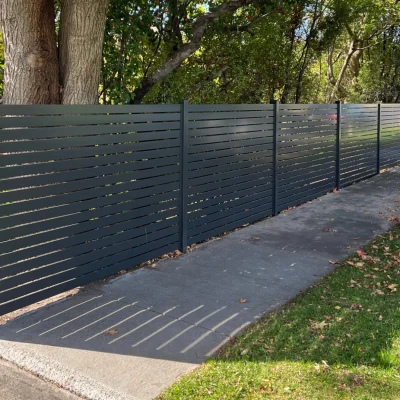 Aluminium slot fencing with dark grey installed in garden