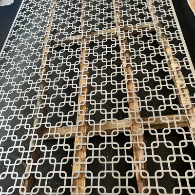 Laser-cut aluminium decorative panel with interlocking geometric design