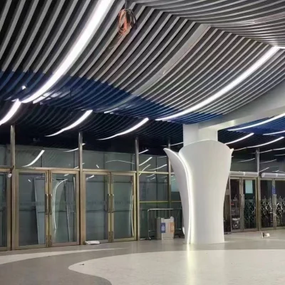Curved aluminium ceiling panels installed in public transit lobby