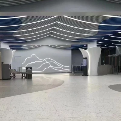 Curved ceiling in white and blue installed in transit lobby space